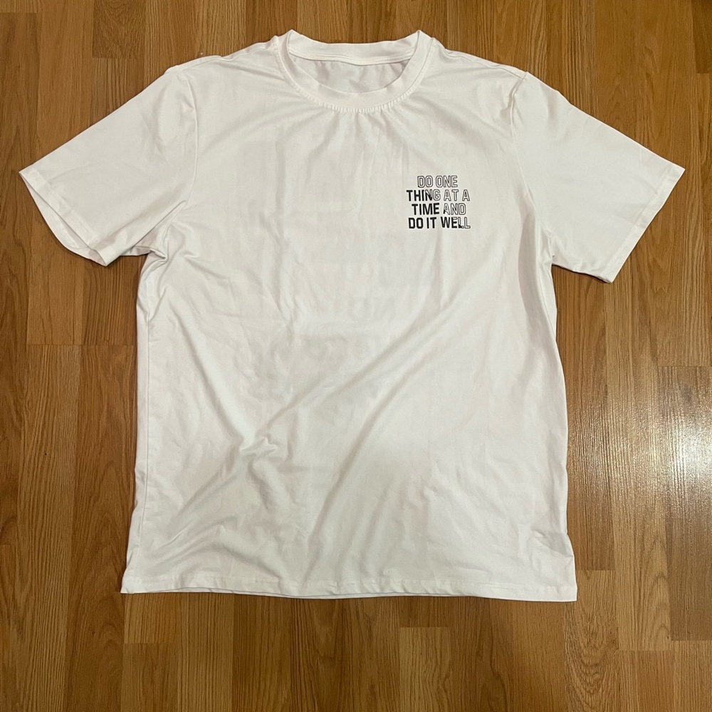 White t-shirt “ Do one thing at a time and do it well”